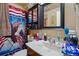 Bathroom with a sink, mirror, and an American flag-themed shower curtain at 12458 E Kansas Pl, Aurora, CO 80012