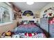 Bright bedroom featuring a comfortable bed, neutral walls, and natural light from a large window at 12458 E Kansas Pl, Aurora, CO 80012