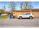 View of the exterior with a white car in the driveway and an attached garage at 12458 E Kansas Pl, Aurora, CO 80012