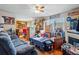 Cozy living room featuring a fireplace, hardwood floors, and bright natural light at 12458 E Kansas Pl, Aurora, CO 80012
