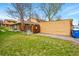 View of the yard with lush green grass next to the building at 12458 E Kansas Pl, Aurora, CO 80012