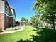 Spacious backyard with lush lawn, mature trees, patio area, and charming pergola at 15857 E Aberdeen Ave, Centennial, CO 80016