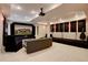 Finished basement with home theater, projector, stage, and comfortable seating at 15857 E Aberdeen Ave, Centennial, CO 80016
