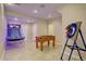 Finished basement game room with basketball game, foosball table, and decorative dart board at 15857 E Aberdeen Ave, Centennial, CO 80016