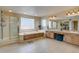 Bright bathroom with a walk-in shower, tub, and double vanity, providing ample space and functionality at 15857 E Aberdeen Ave, Centennial, CO 80016