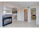 Open bathroom with fireplace, leading into a kitchen and containing toilet room and closet at 15857 E Aberdeen Ave, Centennial, CO 80016