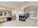 Spacious primary bathroom with fireplace, double vanity, and seamless access to main bedroom at 15857 E Aberdeen Ave, Centennial, CO 80016
