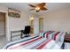Bedroom with two twin beds, desk, television, ceiling fan and access to bathroom at 15857 E Aberdeen Ave, Centennial, CO 80016