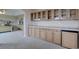 Bedroom featuring a wet bar with wood cabinetry and a beverage fridge, perfect for entertaining guests at 15857 E Aberdeen Ave, Centennial, CO 80016