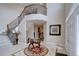 Elegant foyer with a grand staircase, featuring a decorative rug and a bronze horse statue at 15857 E Aberdeen Ave, Centennial, CO 80016