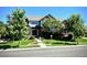Charming home with well-kept lawn, lush landscaping, mature trees, and inviting curb appeal at 15857 E Aberdeen Ave, Centennial, CO 80016