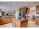 Well-equipped kitchen featuring granite countertops, wooden cabinetry, a central island, and modern stainless steel appliances at 15857 E Aberdeen Ave, Centennial, CO 80016