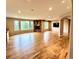 Spacious living room with hardwood floors, stone fireplace, large windows, and ample natural light at 15857 E Aberdeen Ave, Centennial, CO 80016