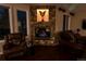 Cozy living room features a stone fireplace with an eagle sculpture and hardwood floors at 15857 E Aberdeen Ave, Centennial, CO 80016