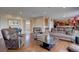 Open-concept living room with hardwood floors and neutral paint, offering a spacious feel at 15857 E Aberdeen Ave, Centennial, CO 80016
