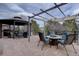Back patio featuring flagstone, dining set, outdoor fireplace, and outdoor kitchen area at 15857 E Aberdeen Ave, Centennial, CO 80016