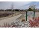Scenic walking trail surrounded by nature, with a sign indicating the Piney Creek Trail at 15857 E Aberdeen Ave, Centennial, CO 80016
