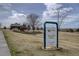 The neighborhood features a park with playground equipment in view behind the sign at 15857 E Aberdeen Ave, Centennial, CO 80016