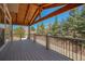 Relaxing covered back deck offering serene outdoor living space at 12518 W 77Th Pl, Arvada, CO 80005
