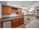 Basement bar features custom cabinetry, sink, mini fridge, and stone backsplash perfect for hosting at 12518 W 77Th Pl, Arvada, CO 80005