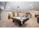 Finished basement with pool table and lounge area with bar and bathroom at 12518 W 77Th Pl, Arvada, CO 80005