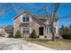 Charming stone-and-siding two-story home with well-manicured front lawn at 12518 W 77Th Pl, Arvada, CO 80005