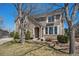 Beautiful two-story home with a stone facade, landscaped yard, and welcoming front entrance at 12518 W 77Th Pl, Arvada, CO 80005