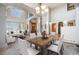 Spacious living room and dining area with large windows and wooden door at 12518 W 77Th Pl, Arvada, CO 80005