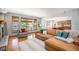Comfortable living room with a cozy fireplace and backyard view at 12518 W 77Th Pl, Arvada, CO 80005