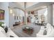 Bright open-concept living room and dining area with soaring ceilings at 12518 W 77Th Pl, Arvada, CO 80005