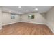 Spacious finished basement with wood-look flooring, recessed lighting, and a modern entertainment area at 90 Moonrise Ct, Erie, CO 80516