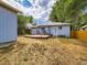Exterior shot of backyard, patio, and the house with blue siding and an orange trim at 1856 S Steele St, Denver, CO 80210