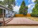 Backyard deck with access to sliding glass doors of home and a wood fence at 1856 S Steele St, Denver, CO 80210