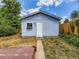 Exterior photo of a shed in the backyard with a white door and small window with flower box at 1856 S Steele St, Denver, CO 80210