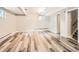 Finished basement with wood-style floors, track lighting, and white walls at 1856 S Steele St, Denver, CO 80210