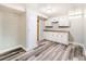 Open basement area with updated floors, recessed lighting, cabinets, and a door to another room at 1856 S Steele St, Denver, CO 80210