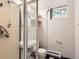 Cozy bathroom with a glass shower, tiled walls, and checkered flooring at 1856 S Steele St, Denver, CO 80210