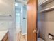 View of a tiled bathroom featuring white tiled walls, and a wooden door partially open at 1856 S Steele St, Denver, CO 80210