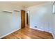 Bedroom with hardwood floors, built-in shelving, and a neutral color scheme at 1856 S Steele St, Denver, CO 80210