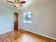 Bright bedroom with hardwood floors, a ceiling fan, and a window view at 1856 S Steele St, Denver, CO 80210