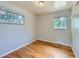 Inviting bedroom with gleaming hardwood floors and dual windows providing natural light at 1856 S Steele St, Denver, CO 80210