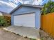 Spacious garage with a white door, ample parking, and a tidy exterior at 1856 S Steele St, Denver, CO 80210