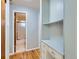 Hallway featuring hardwood floors, a built in desk and cabinets, and a view of the bathroom at 1856 S Steele St, Denver, CO 80210