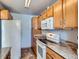 Kitchen featuring ample cabinetry, white appliances, and stone countertops at 1856 S Steele St, Denver, CO 80210