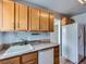 Kitchen with white sink, wood cabinets, and white appliances and counter tops at 1856 S Steele St, Denver, CO 80210