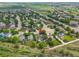 Aerial view of a charming home nestled in a lush community, surrounded by mature trees and well-manicured lawns at 2205 Santa Fe Dr, Longmont, CO 80504