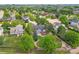 Aerial view of a home in a peaceful neighborhood surrounded by mature trees and lush landscaping at 2205 Santa Fe Dr, Longmont, CO 80504