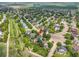 Aerial view of the home nestled in a quiet neighborhood featuring mature trees and lush green space at 2205 Santa Fe Dr, Longmont, CO 80504
