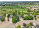 Aerial view showcasing lush green scenery, the golf course, and surrounding neighborhood at 2205 Santa Fe Dr, Longmont, CO 80504