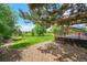 Serene backyard featuring a pergola-covered deck and mature trees for a private outdoor escape at 2205 Santa Fe Dr, Longmont, CO 80504